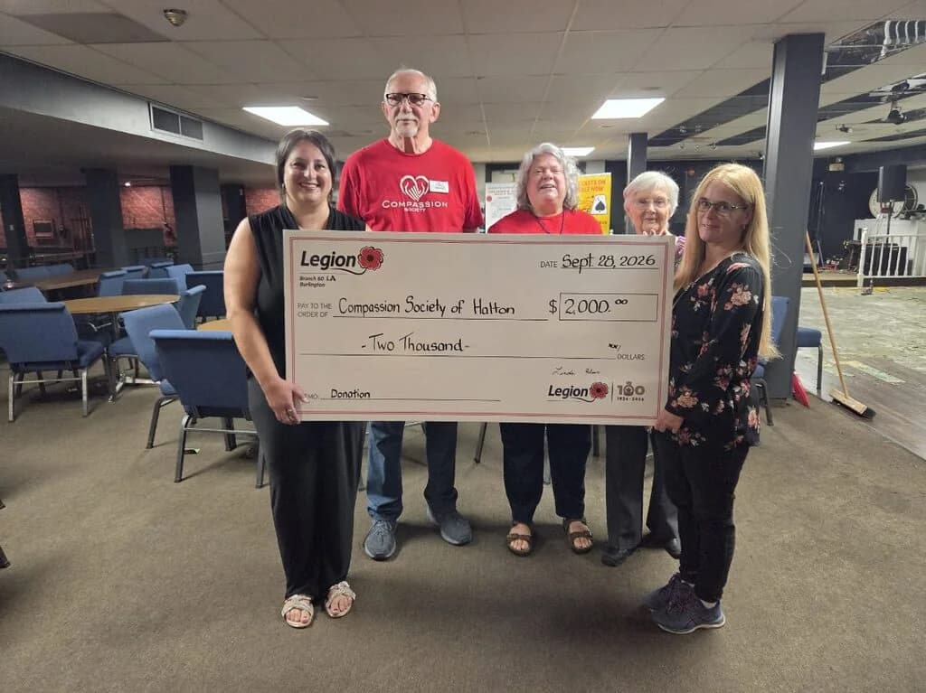 Compassion Society of Halton volunteers accept a $2,000 donation cheque from a local Royal Canadian Legion branch.